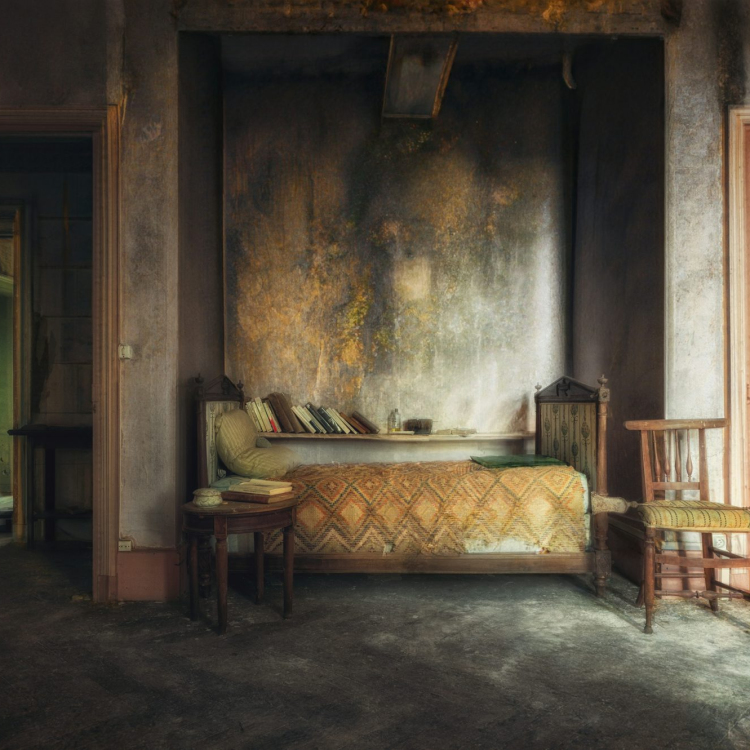 A bedroom with a bed and chair