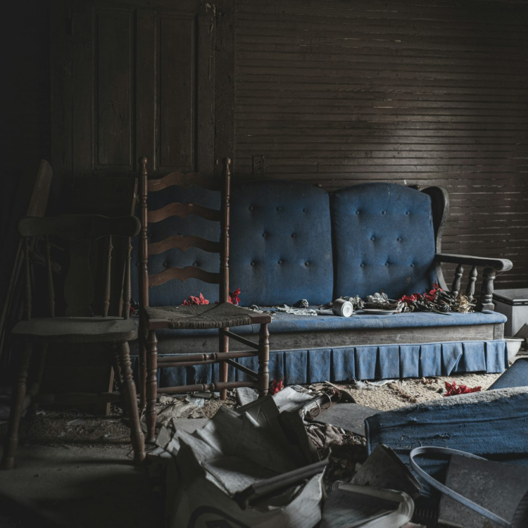 A blue couch sitting in a room next to a chair