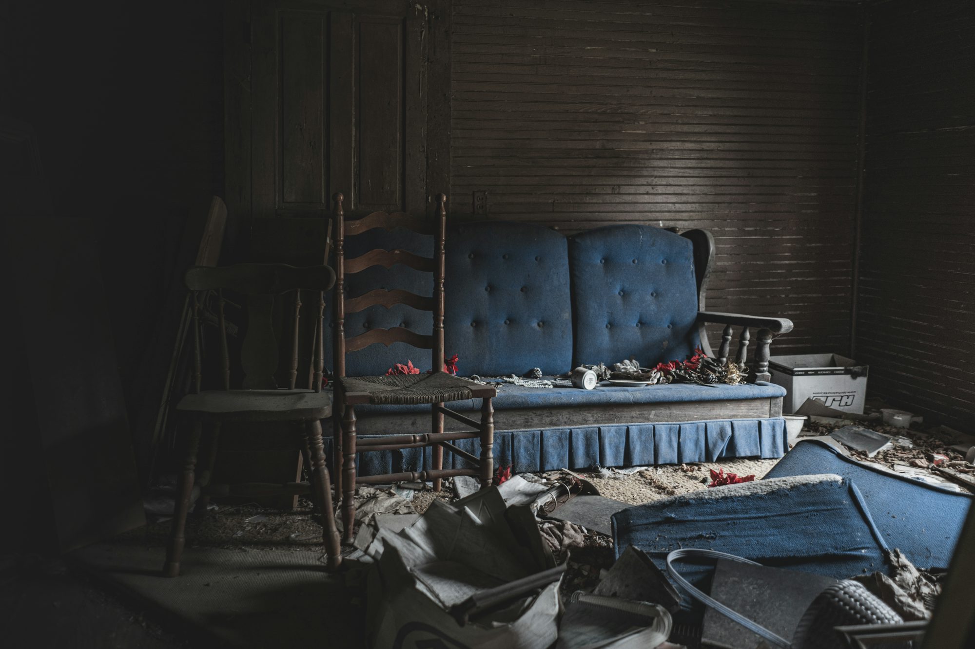 A blue couch sitting in a room next to a chair