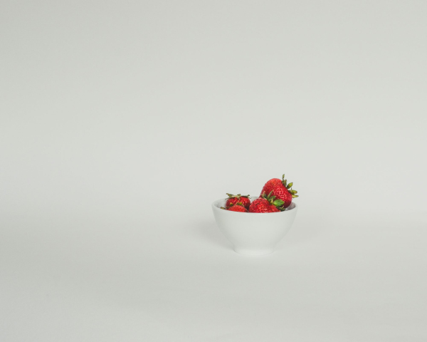 A bowl of strawberries on a white background