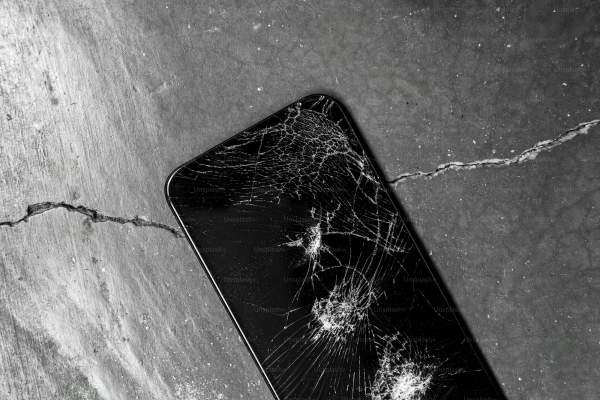 A broken cell phone sitting on top of a table