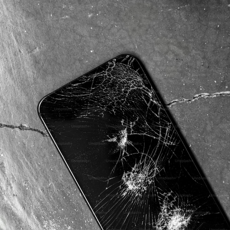 A broken cell phone sitting on top of a table