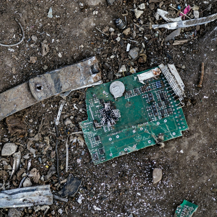 A broken circuit board laying on the ground