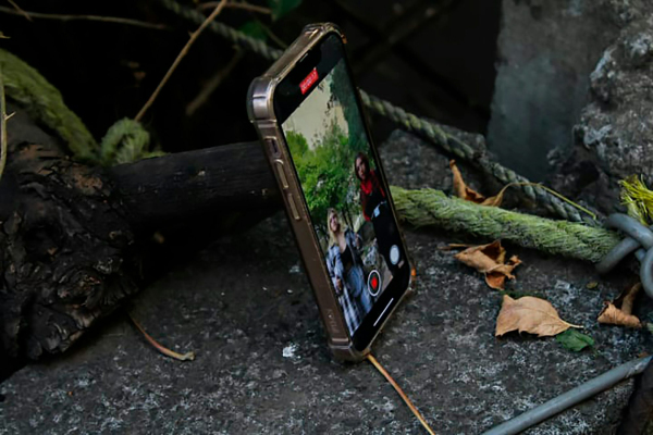A cell phone sitting on top of a rock