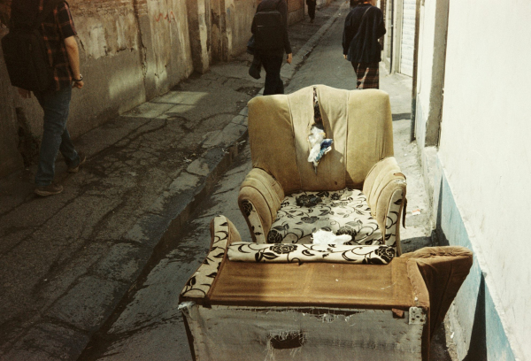 A chair that is sitting in the middle of a street