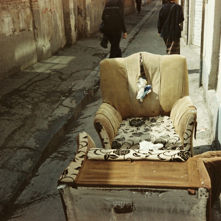 A chair that is sitting in the middle of a street