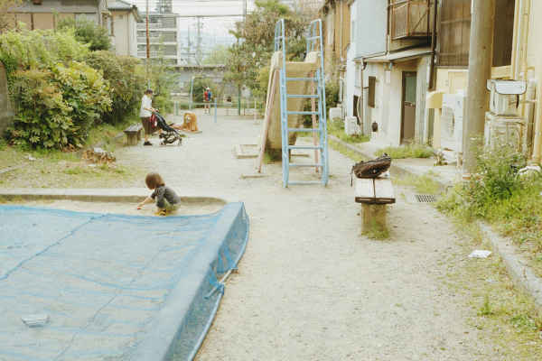 A child plays in a sandy playground