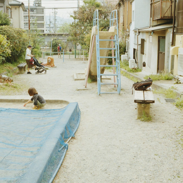 A child plays in a sandy playground