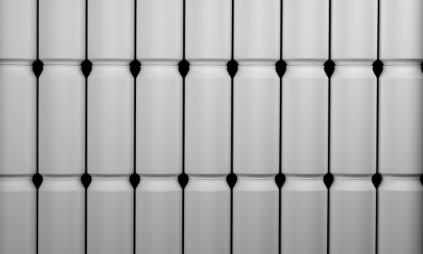 A close up of a white wall with black dots