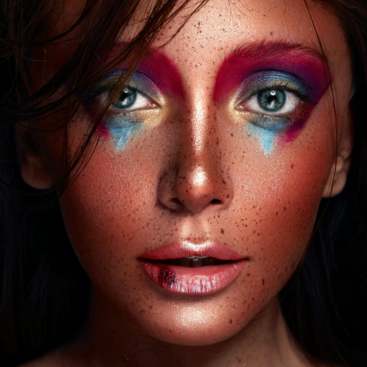A close up of a woman with freckles on her face