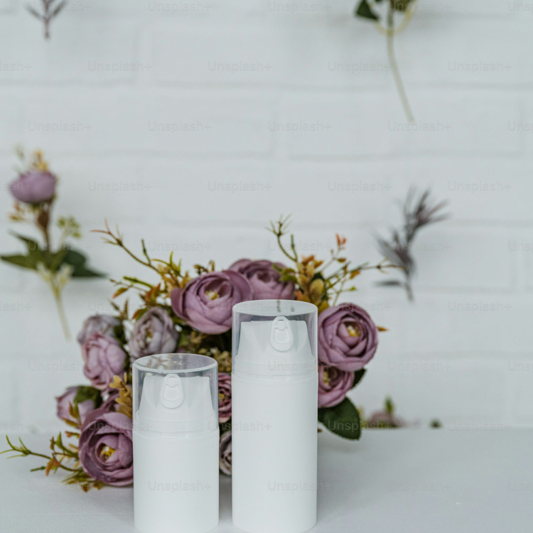A couple of white candles sitting on top of a table
