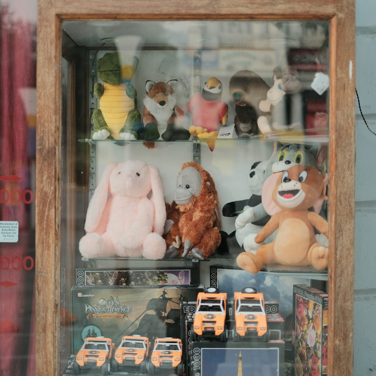 A display case filled with lots of stuffed animals