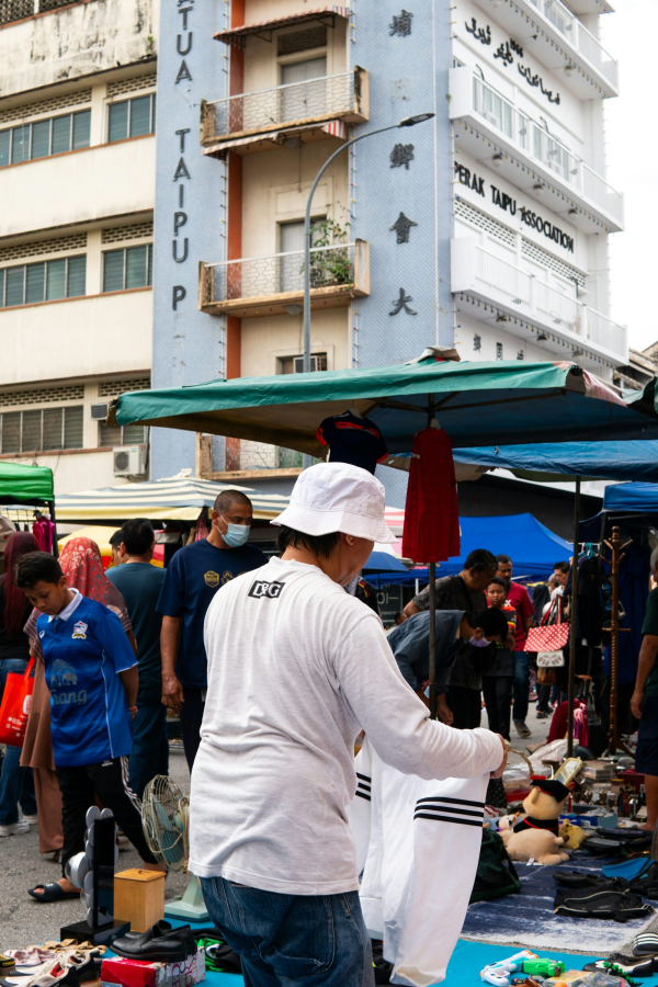 A group of people standing around a market