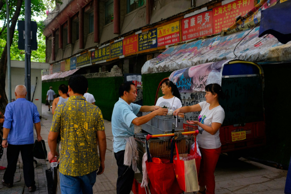 A group of people walking down a street