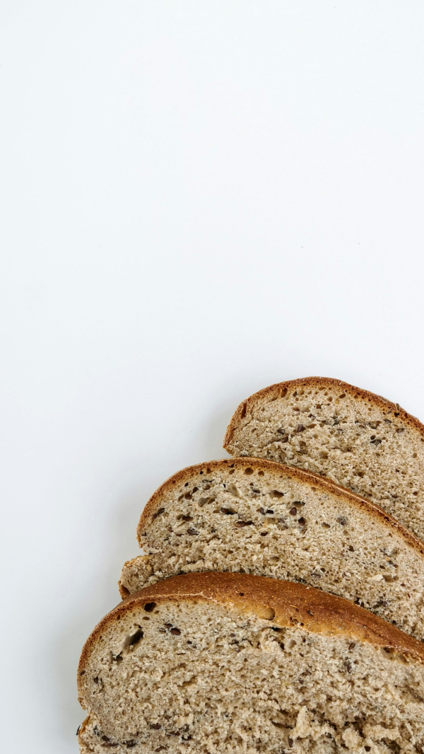 A loaf of whole wheat bread on a white surface