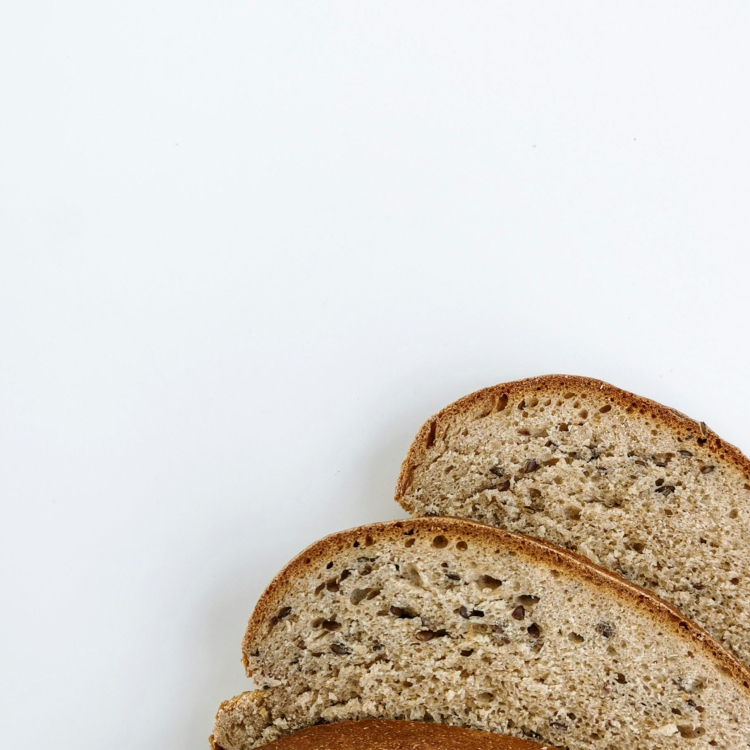 A loaf of whole wheat bread on a white surface