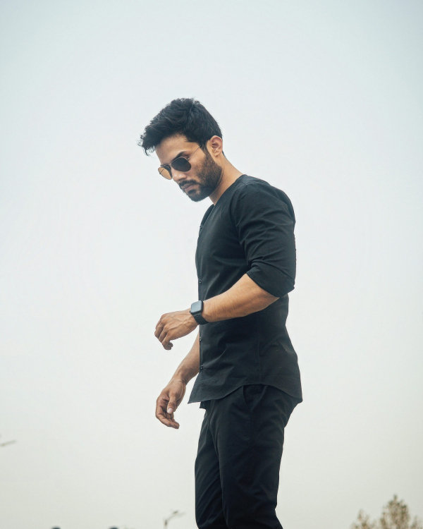 A man in black looks down