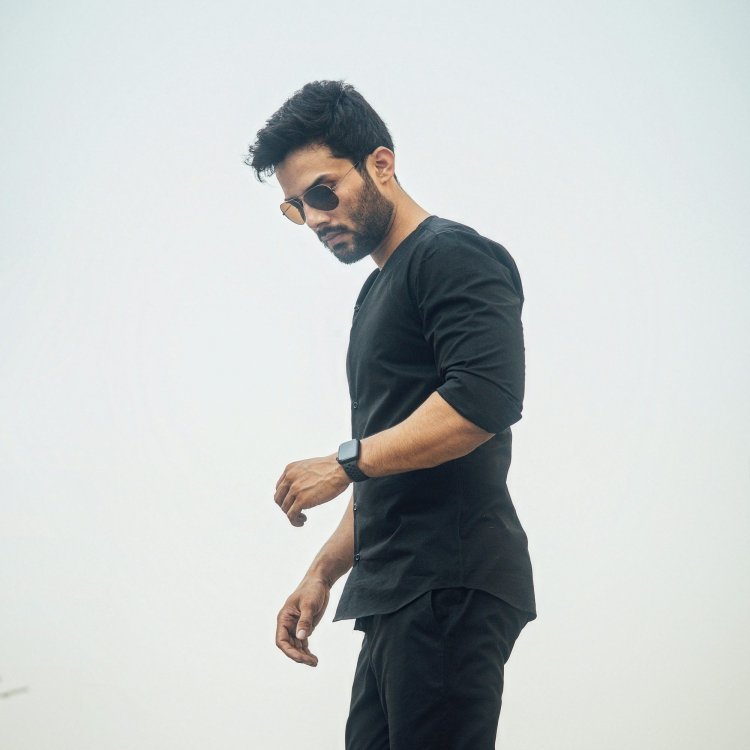 A man in black looks down