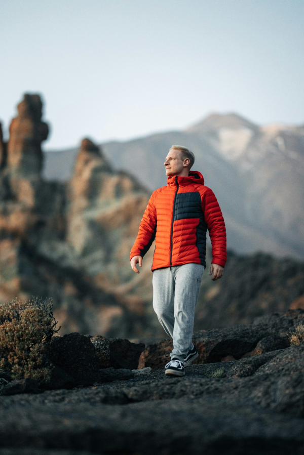 A man standing on top of a rocky mountain