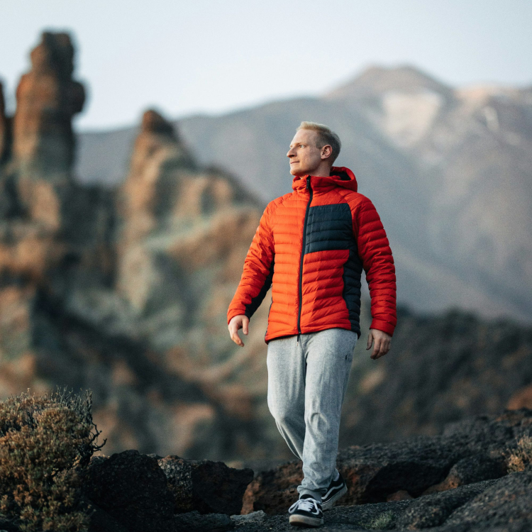 A man standing on top of a rocky mountain