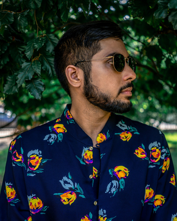 A man with a beard wearing a flower shirt