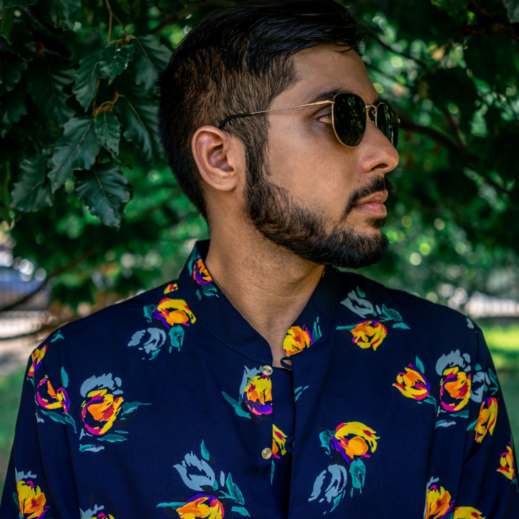 A man with a beard wearing a flower shirt