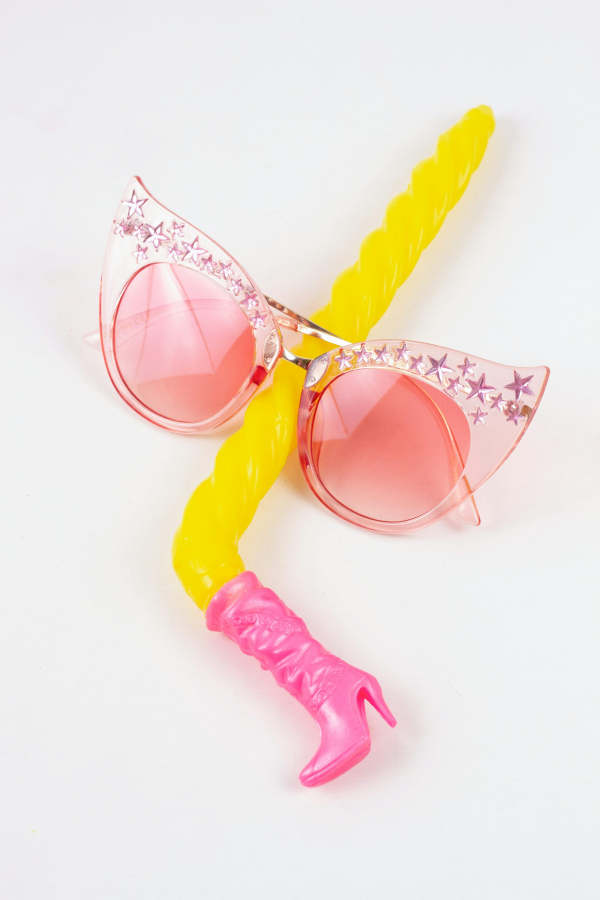 A pair of pink sunglasses with a yellow handle