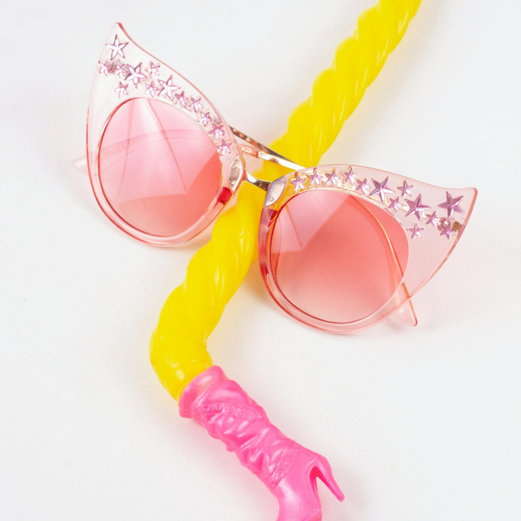 A pair of pink sunglasses with a yellow handle