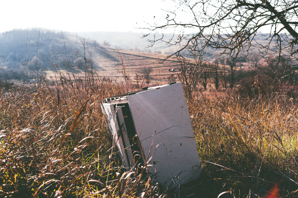 A refrigerator sitting in the middle of a field