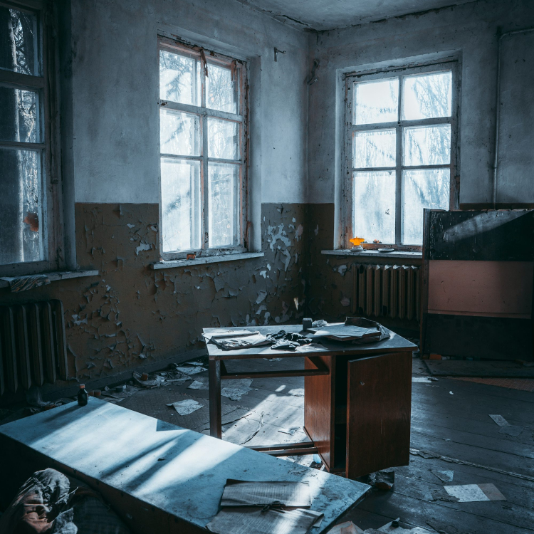 A room with a desk and two windows