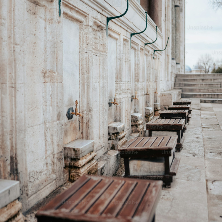 A row of wooden benches sitting next to a building