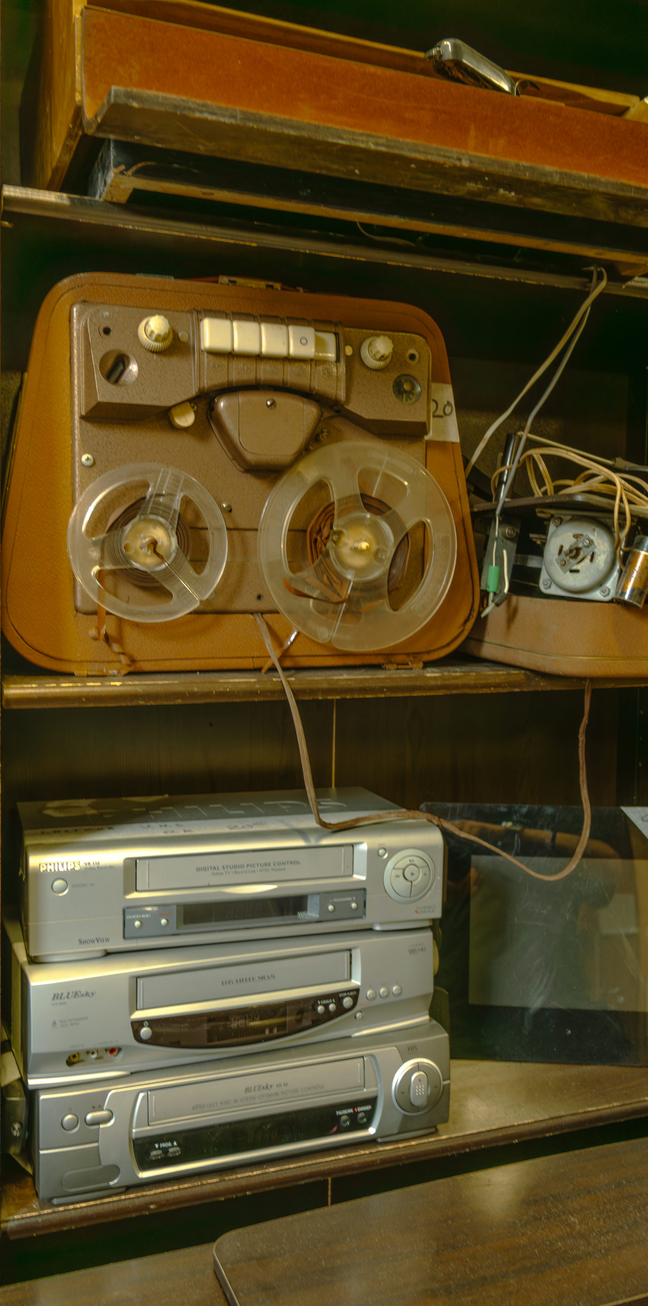 A shelf with a bunch of electronics on top of it