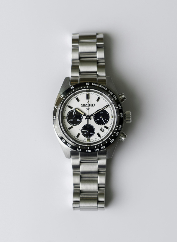 A silver watch with a black face