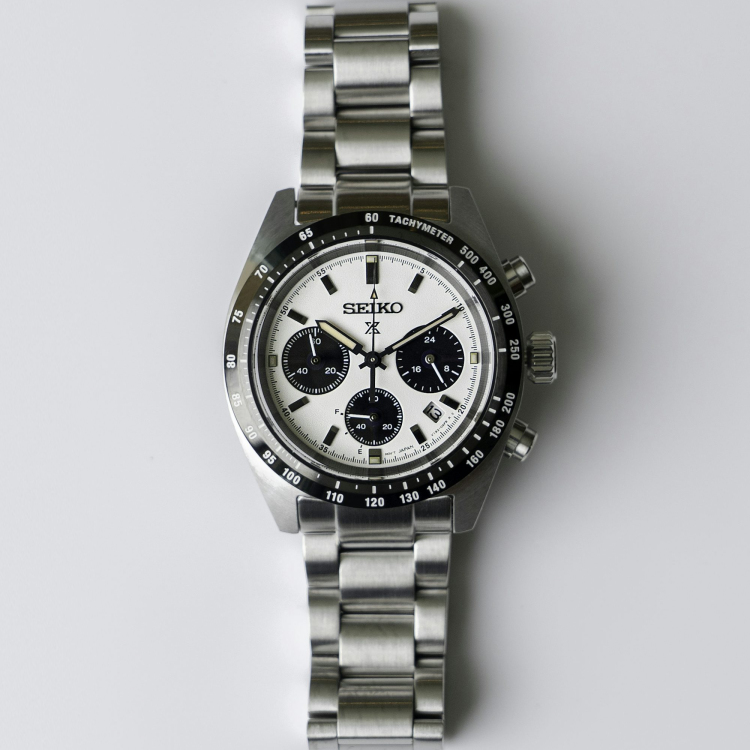 A silver watch with a black face