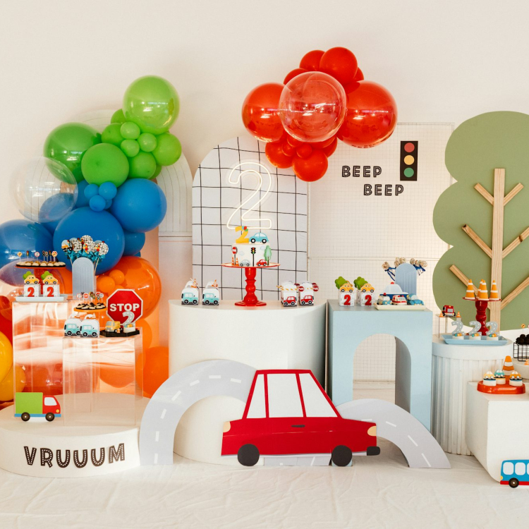 A transportation-themed party has colorful decorations
