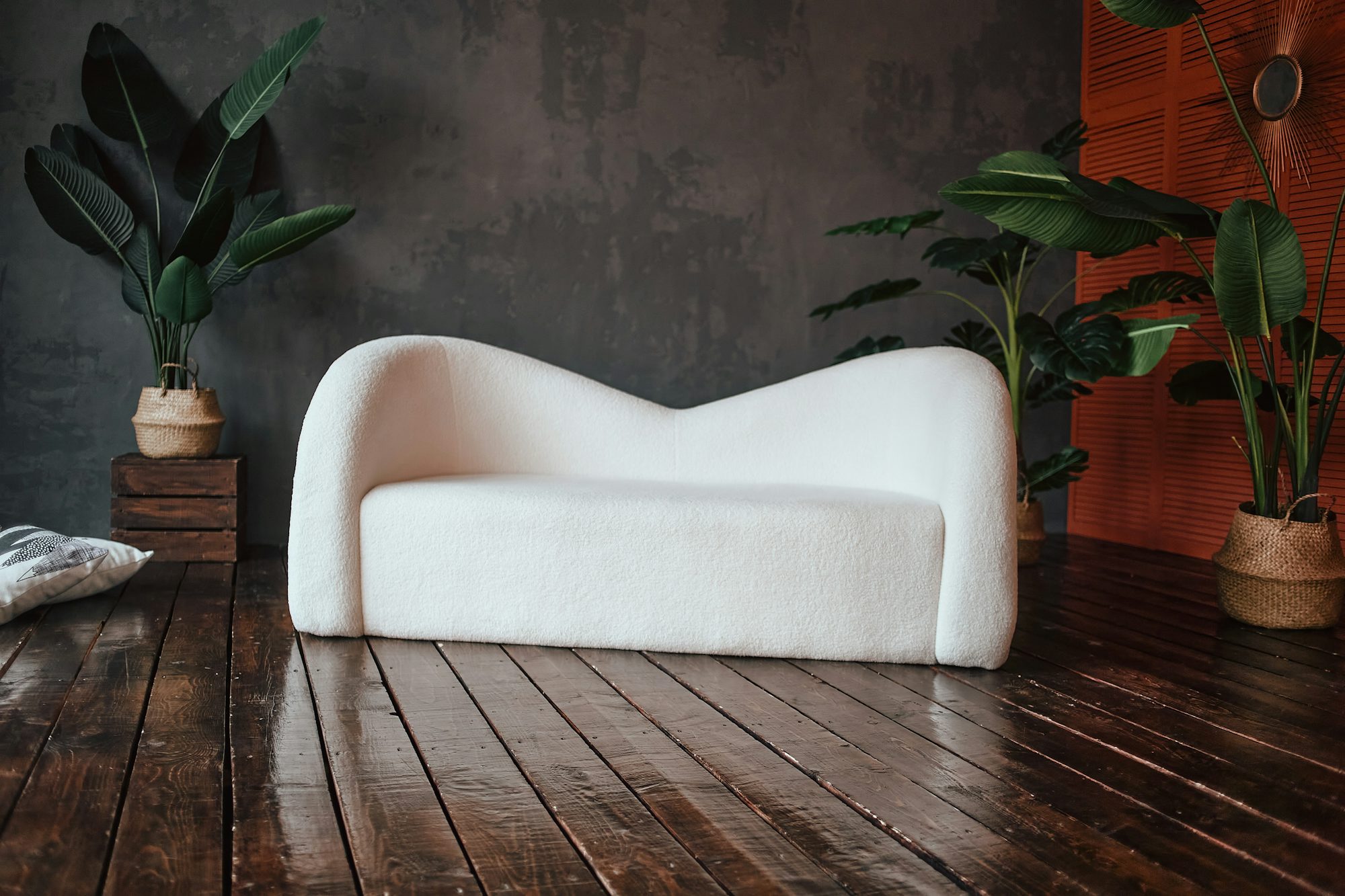 A white couch sitting on top of a wooden floor