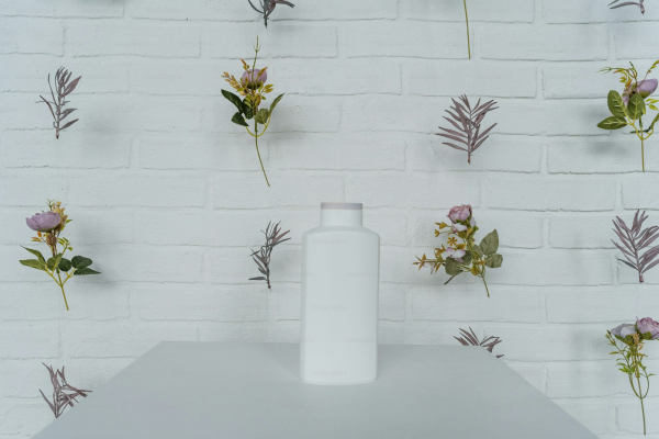 A white vase sitting on top of a white table