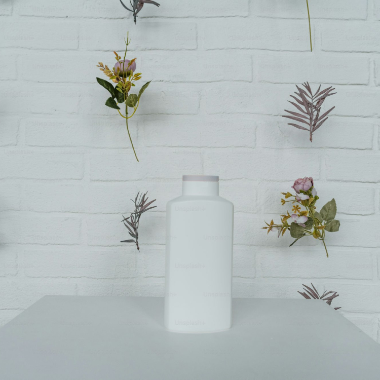 A white vase sitting on top of a white table