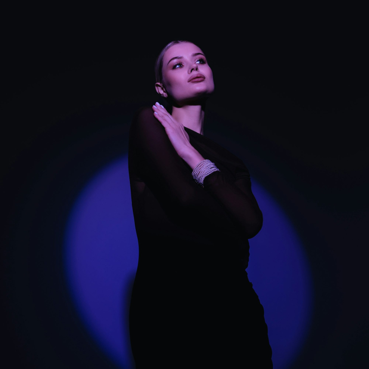 A woman in a black dress posing for a picture