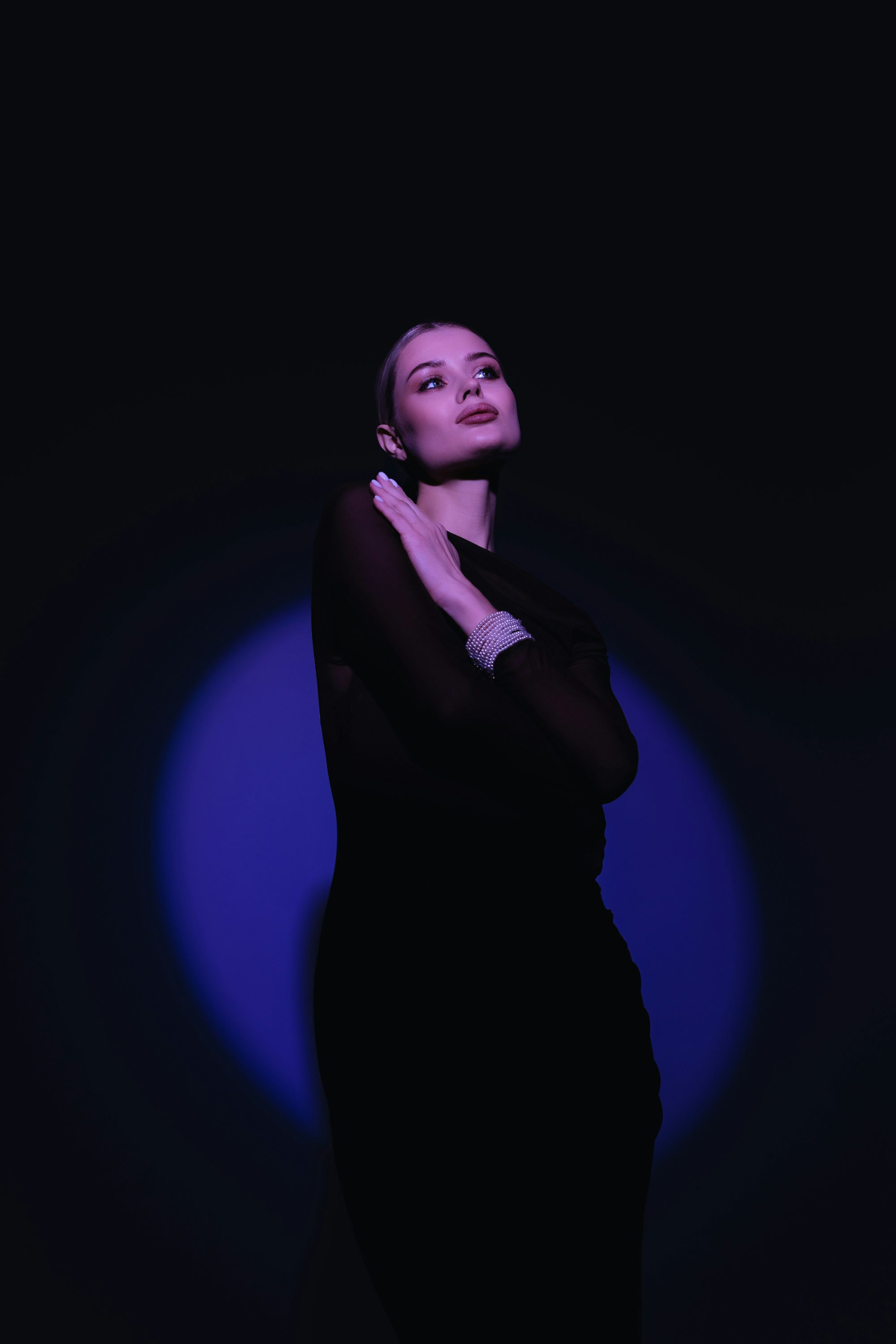 A woman in a black dress posing for a picture