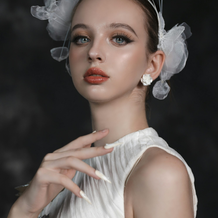 A woman in a white dress with a flower in her hair