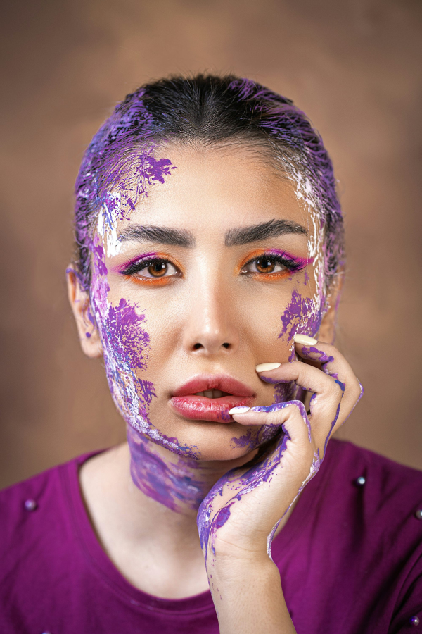 A woman is covered in purple paint