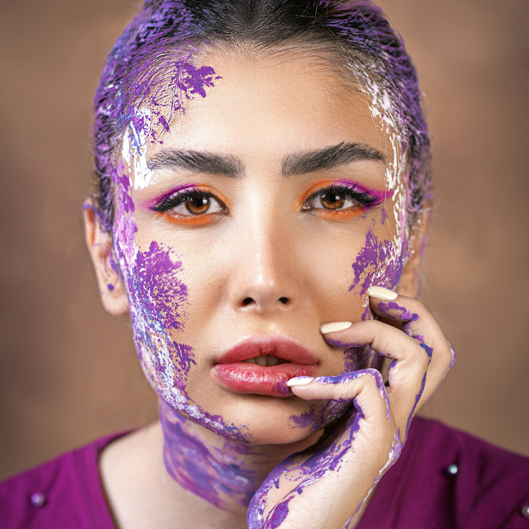 A woman is covered in purple paint