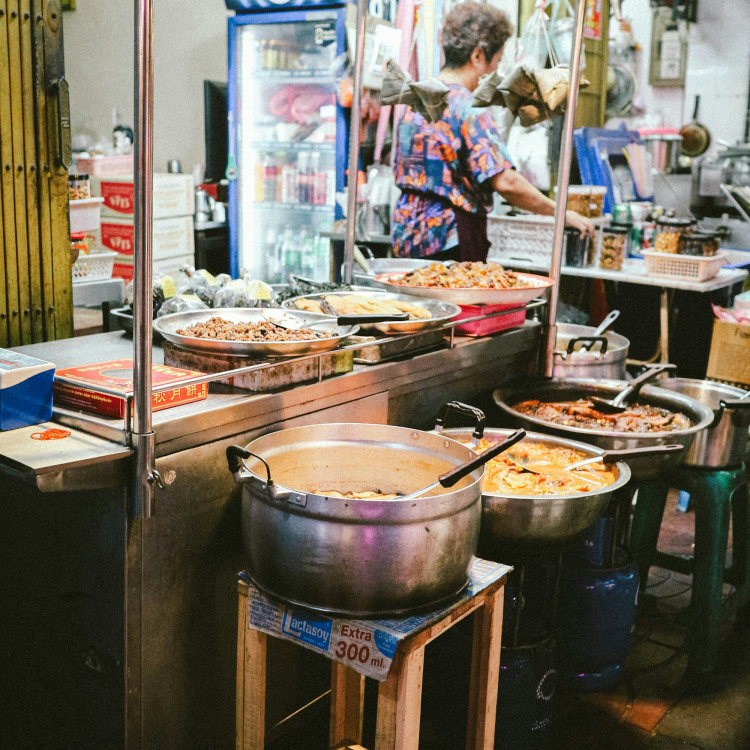 A woman preparing food in a restaurant kitchen