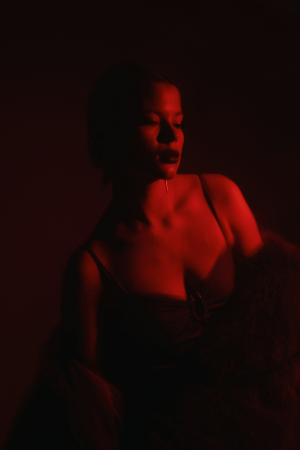 A woman sitting in a chair in a dark room