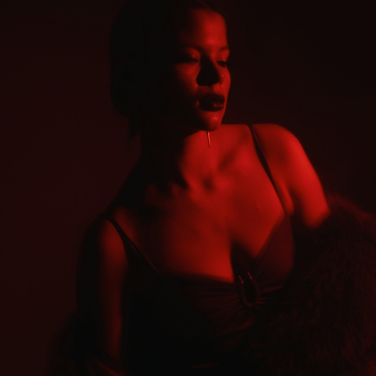 A woman sitting in a chair in a dark room