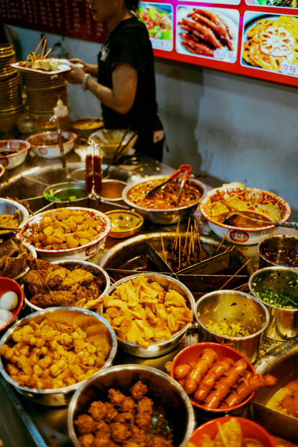 A woman standing in front of a table full of food