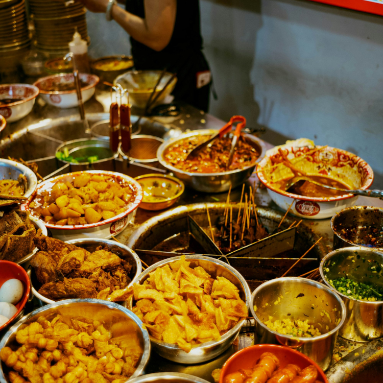 A woman standing in front of a table full of food