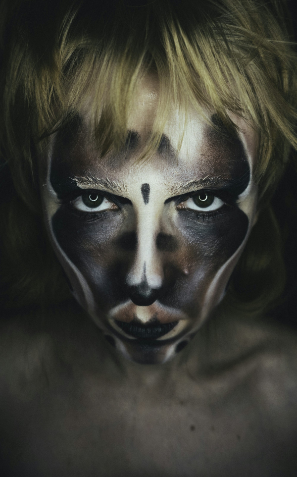 A woman with a face painted like a cat