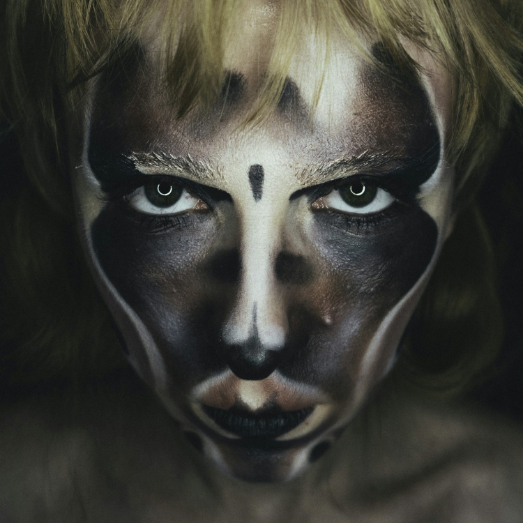 A woman with a face painted like a cat